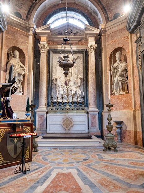 Altar inside the National Palace of Mafra with ornate sculptures and decorative elements.