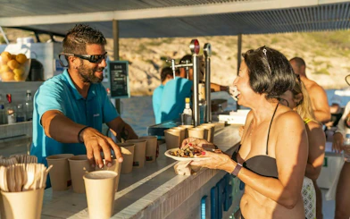 Tourist enjoying refreshments on a sunset boat in Mallorca.