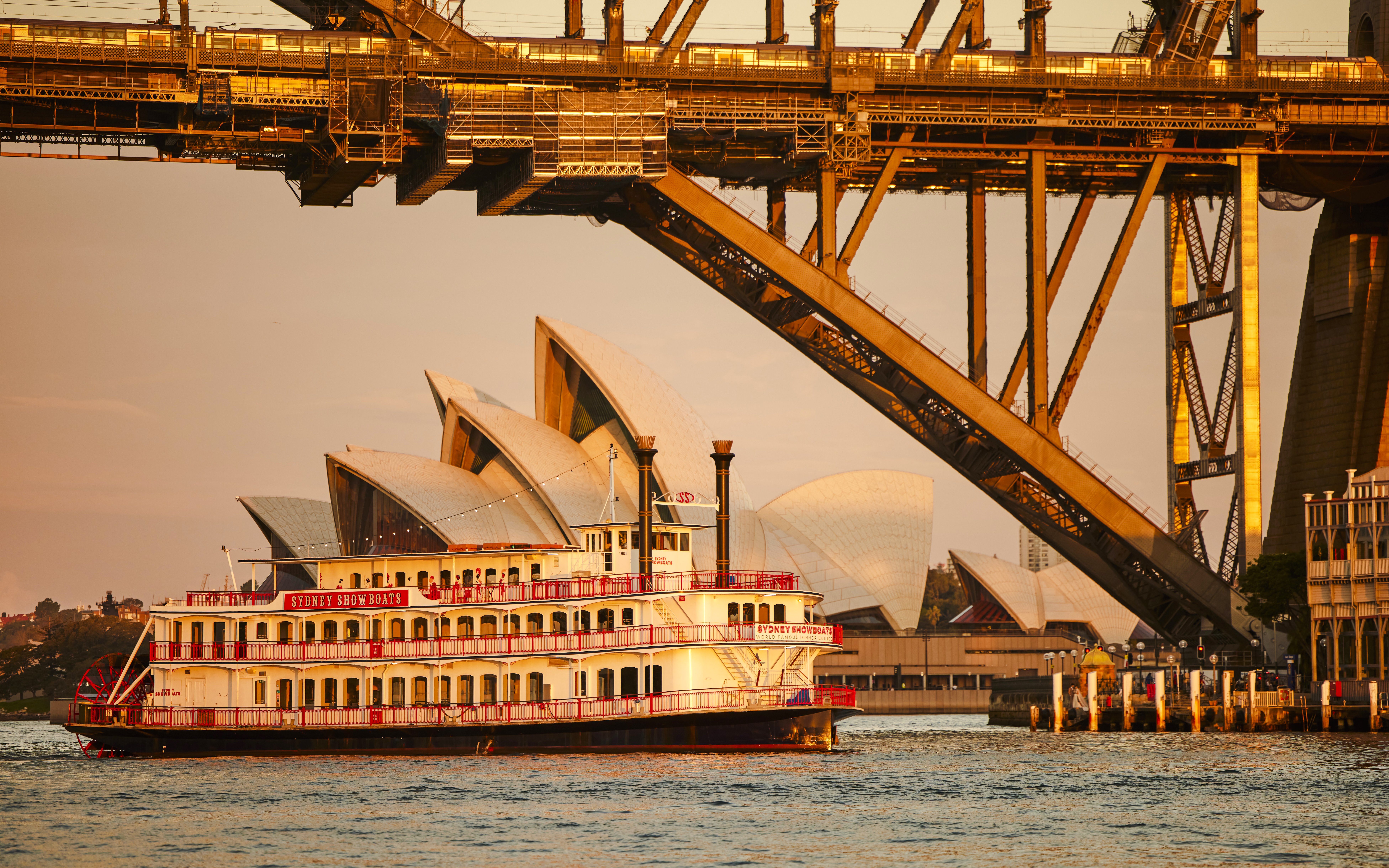 Showboat on Sydney Harbour with Opera House and Harbour Bridge in background.