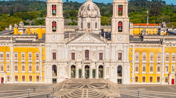 National Palace of Mafra facade with twin bell towers and central dome, Portugal.
