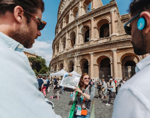 Tour guide with group at the Colosseum in Rome.
