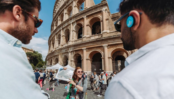 Tour guide with group at the Colosseum in Rome.