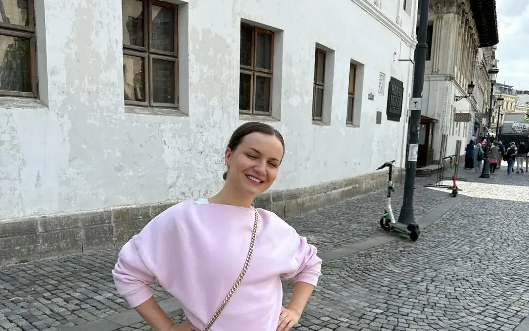 Person standing on a cobblestone street in Bucharest during a self-guided city exploration game.