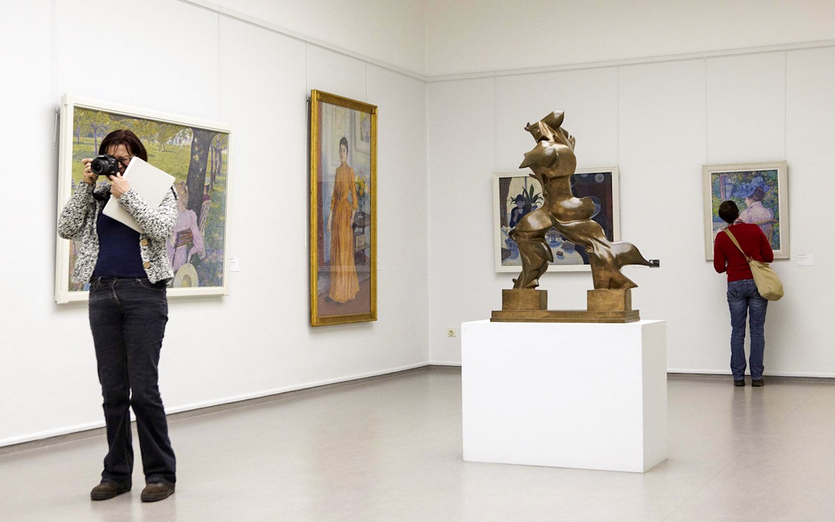 Visitors viewing art and sculpture at Kröller Müller Museum, Netherlands.