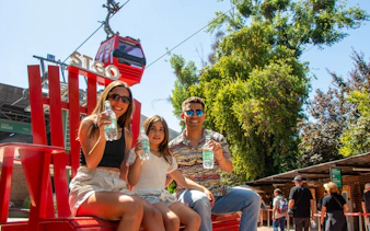Family enjoying drinks near Santiago Teleférico in Metropolitan Park, Santiago.