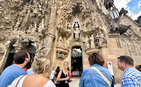 Tour group at Sagrada Familia's intricate facade in Barcelona.
