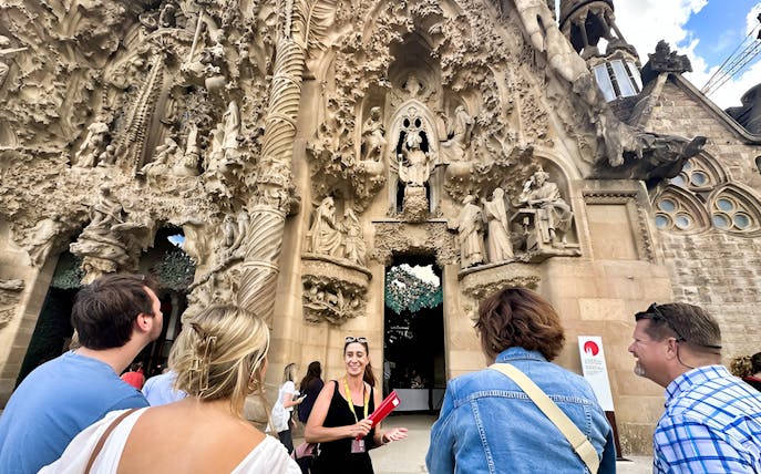 Tour group at Sagrada Familia's intricate facade in Barcelona.