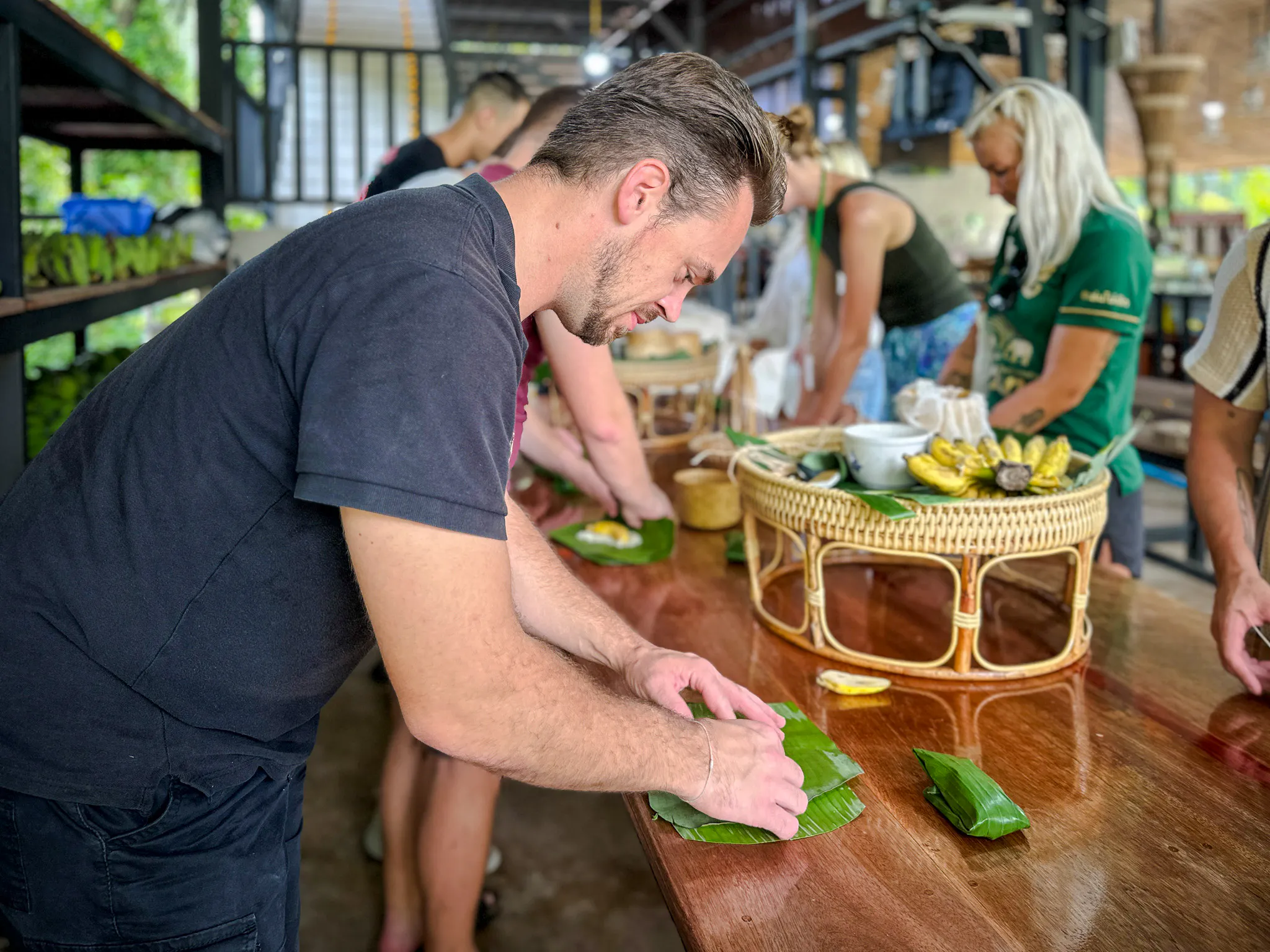 Visitors preparing food at Krabi Roaming Elephant Sanctuary, Thailand.