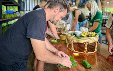 Visitors preparing food at Krabi Roaming Elephant Sanctuary, Thailand.