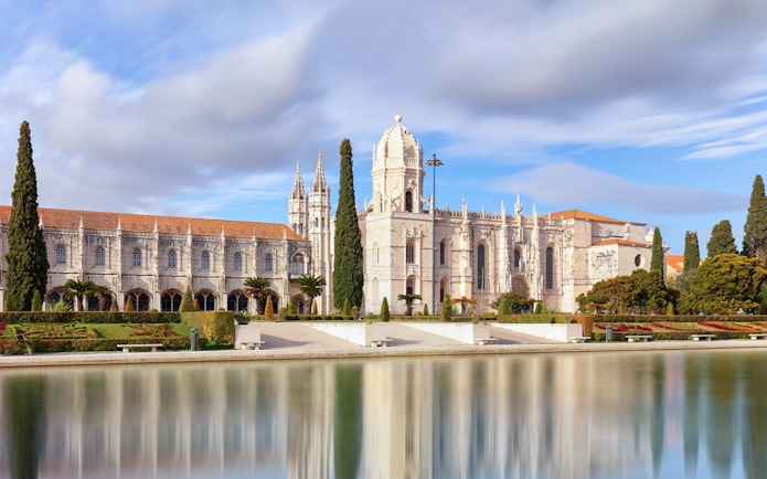 Jerónimos Monastery in Lisbon with reflection in water, part of Belém Essential Combo tour.