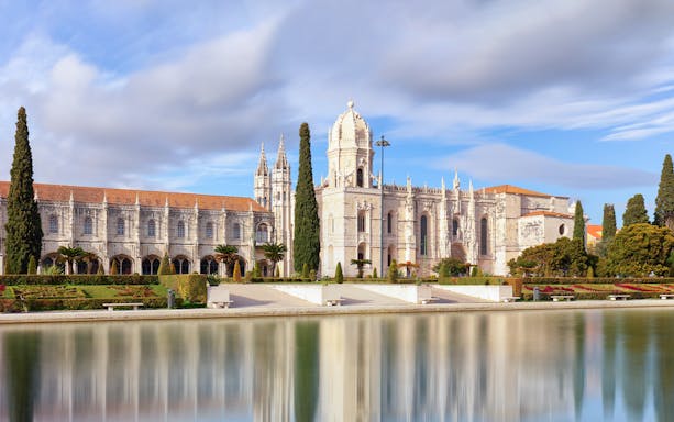 Jerónimos Monastery in Lisbon with reflection in water, part of Belém Essential Combo tour.