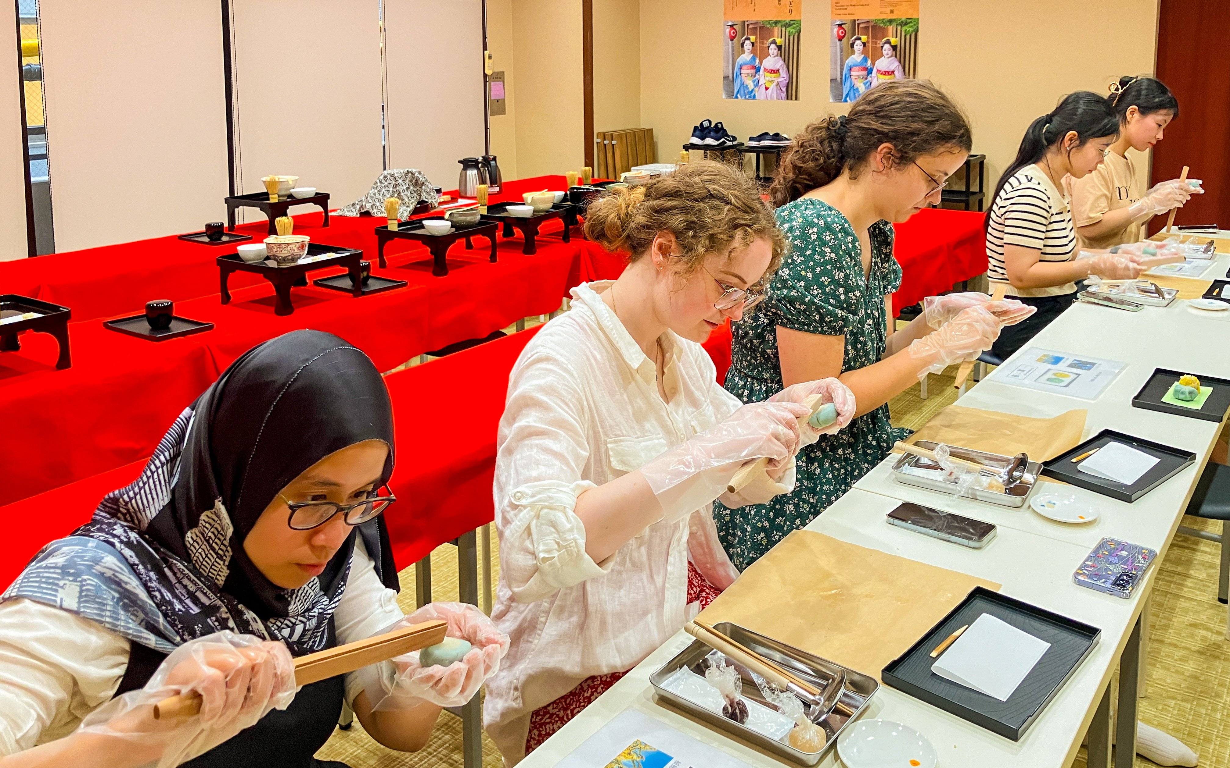 Participants crafting traditional Japanese sweets in a workshop setting.