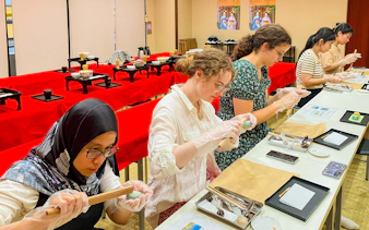 Participants crafting traditional Japanese sweets in a workshop setting.