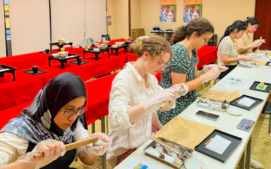 Participants crafting traditional Japanese sweets in a workshop setting.