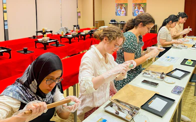 Participants crafting traditional Japanese sweets in a workshop setting.