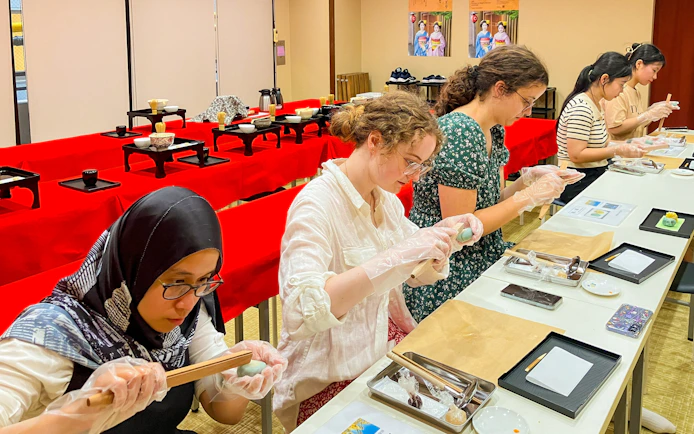 Participants crafting traditional Japanese sweets in a workshop setting.