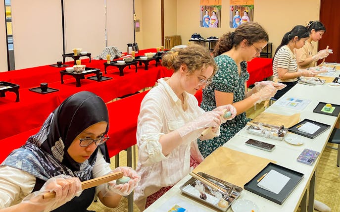 Participants crafting traditional Japanese sweets in a workshop setting.