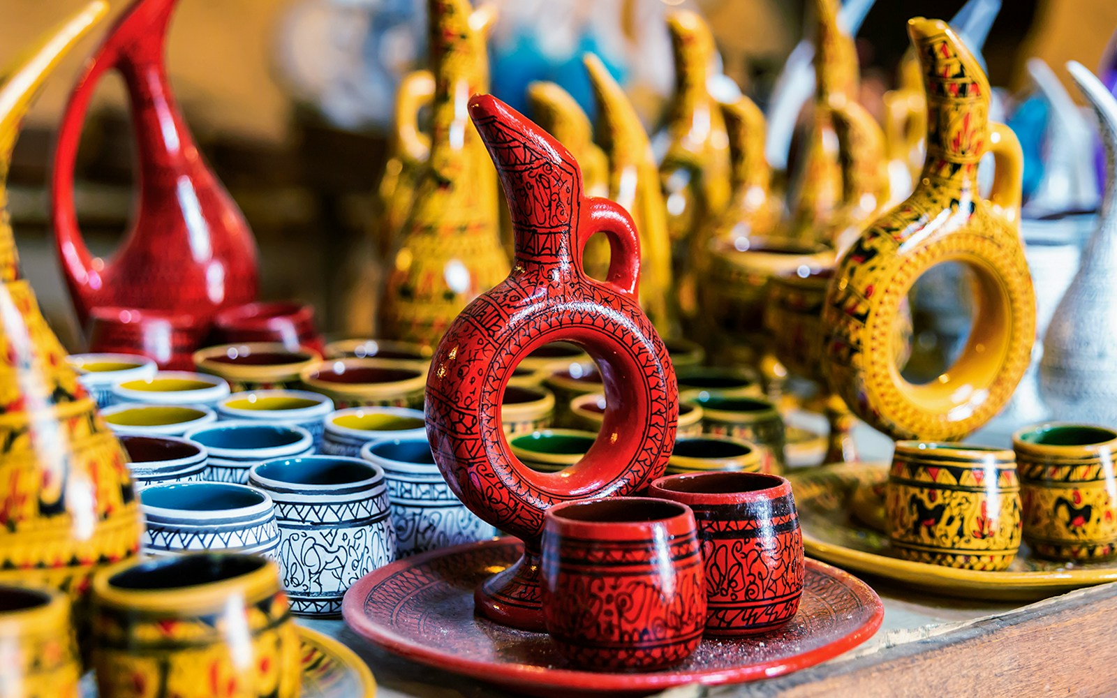 Cappadocian pottery display in Avanos featuring colorful jugs and cups.