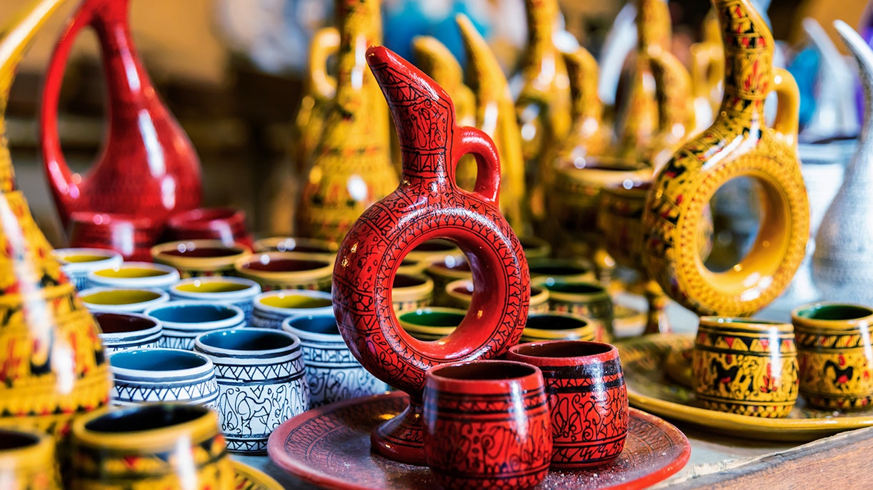 Cappadocian pottery display in Avanos featuring colorful jugs and cups.