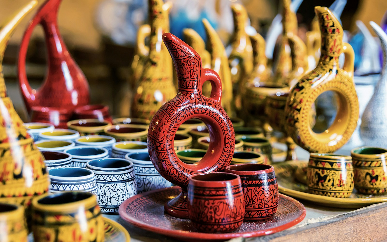 Cappadocian pottery display in Avanos featuring colorful jugs and cups.