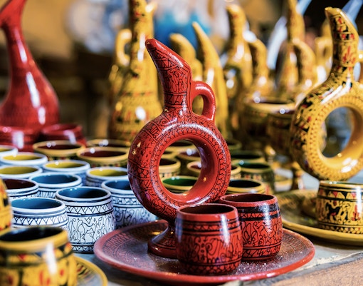 Cappadocian pottery display in Avanos featuring colorful jugs and cups.