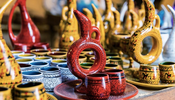 Cappadocian pottery display in Avanos featuring colorful jugs and cups.