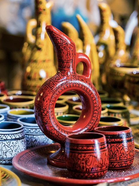 Cappadocian pottery display in Avanos featuring colorful jugs and cups.