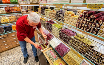 Man arranging Turkish delight in a shop during an Istanbul food tour.
