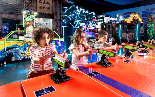 Children playing arcade games at Play DXB indoor amusement park.
