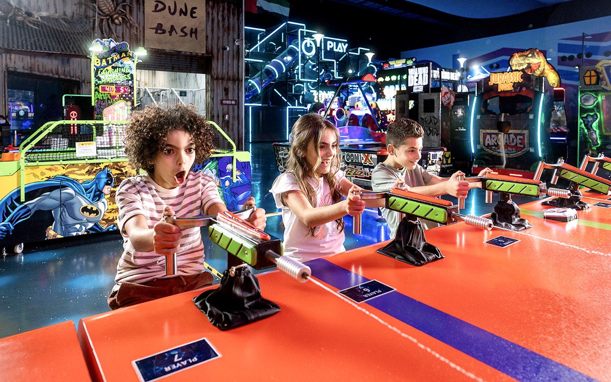 Children playing arcade games at Play DXB indoor amusement park.