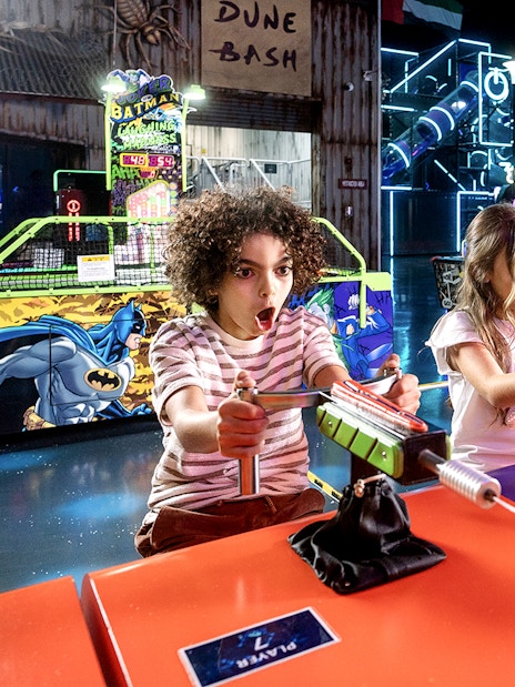 Children playing arcade games at Play DXB indoor amusement park.