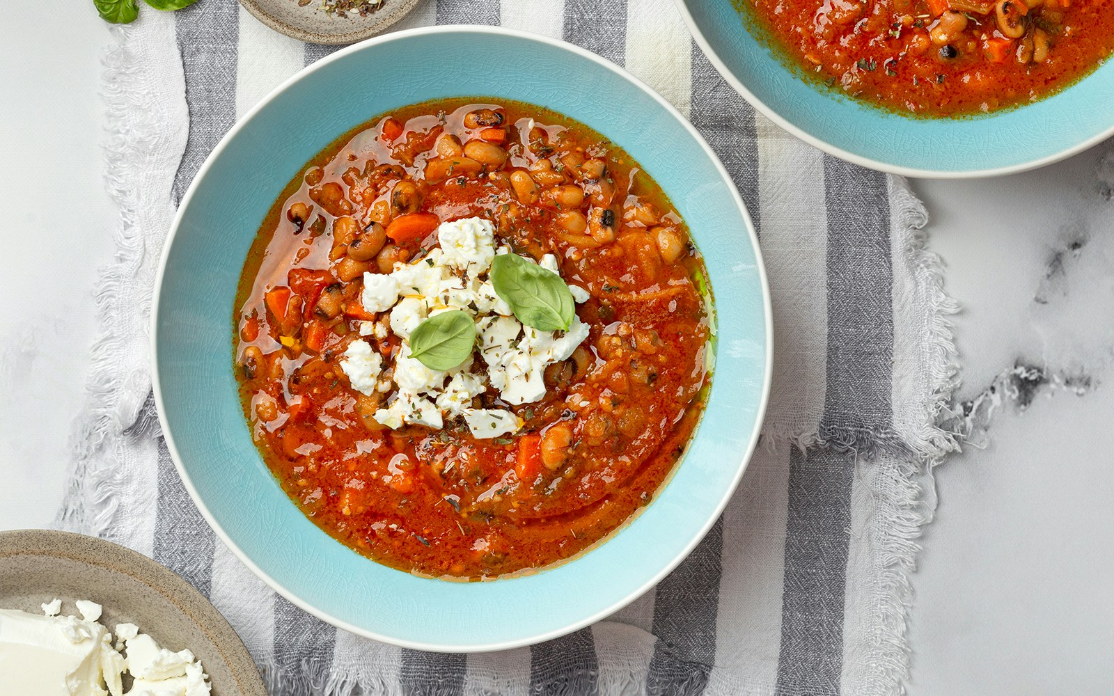Fasolada soup with beans and feta in a blue bowl, Athens in December.