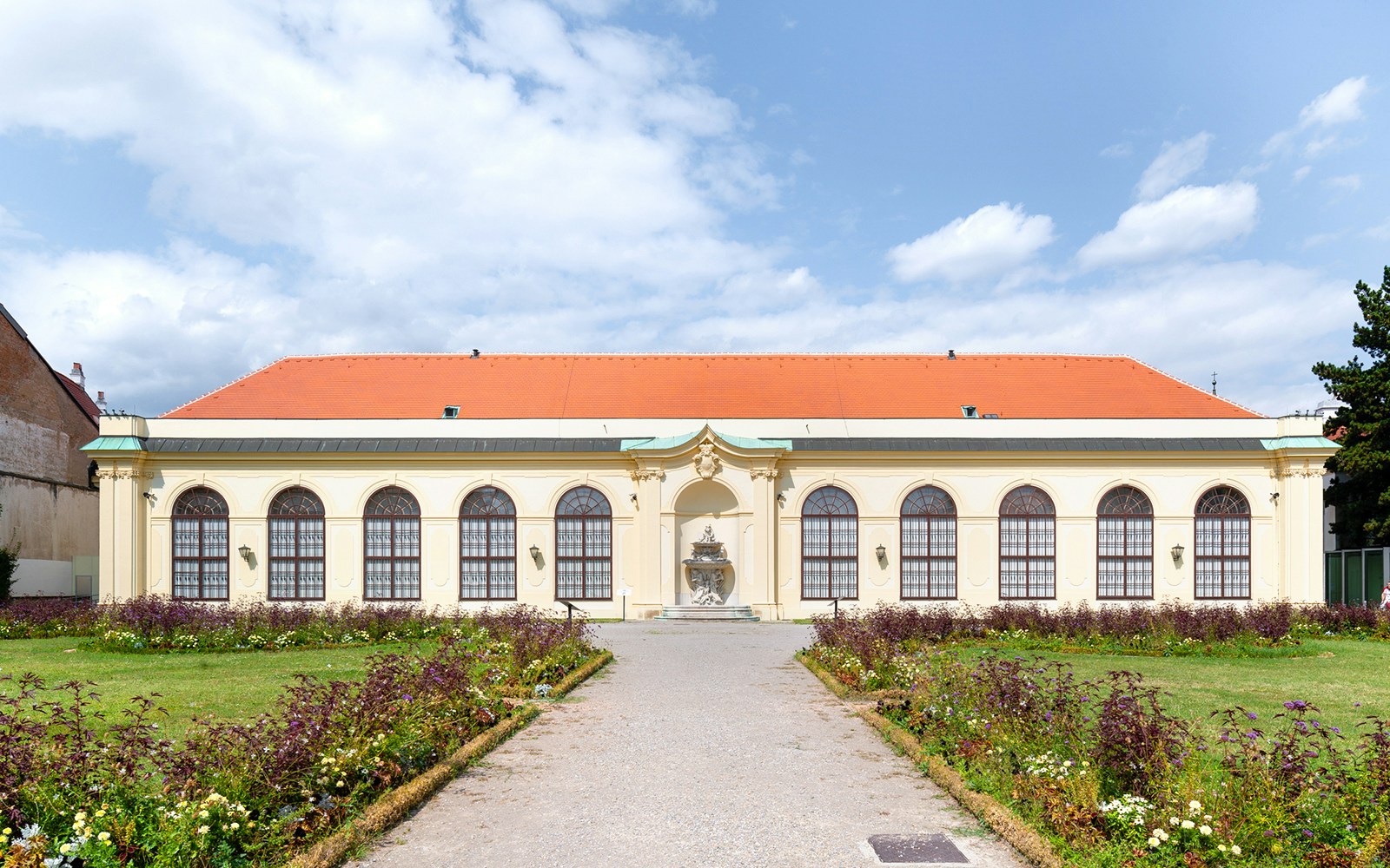 Orangery at Lower Belvedere Palace with garden path, Vienna.