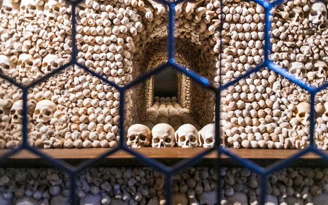 Bone skulls and skeletons arranged inside the Bone Church, Kutna Hora.