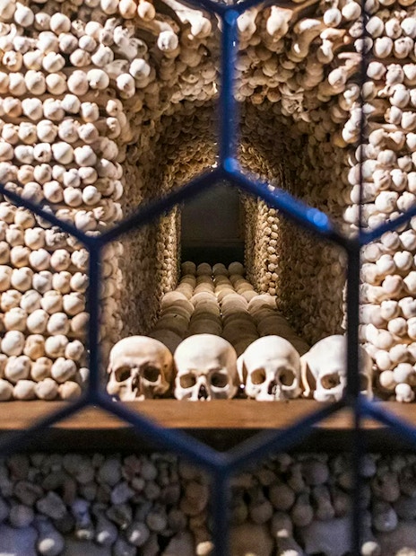 Bone skulls and skeletons arranged inside the Bone Church, Kutna Hora.