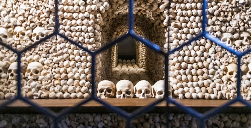 Bone skulls and skeletons arranged inside the Bone Church, Kutna Hora.