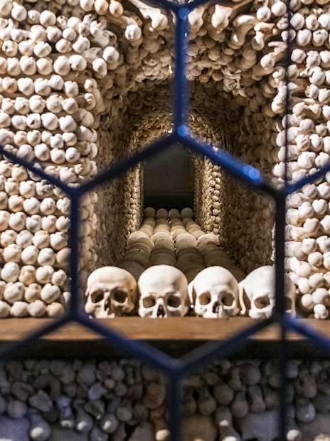 Bone skulls and skeletons arranged inside the Bone Church, Kutna Hora.