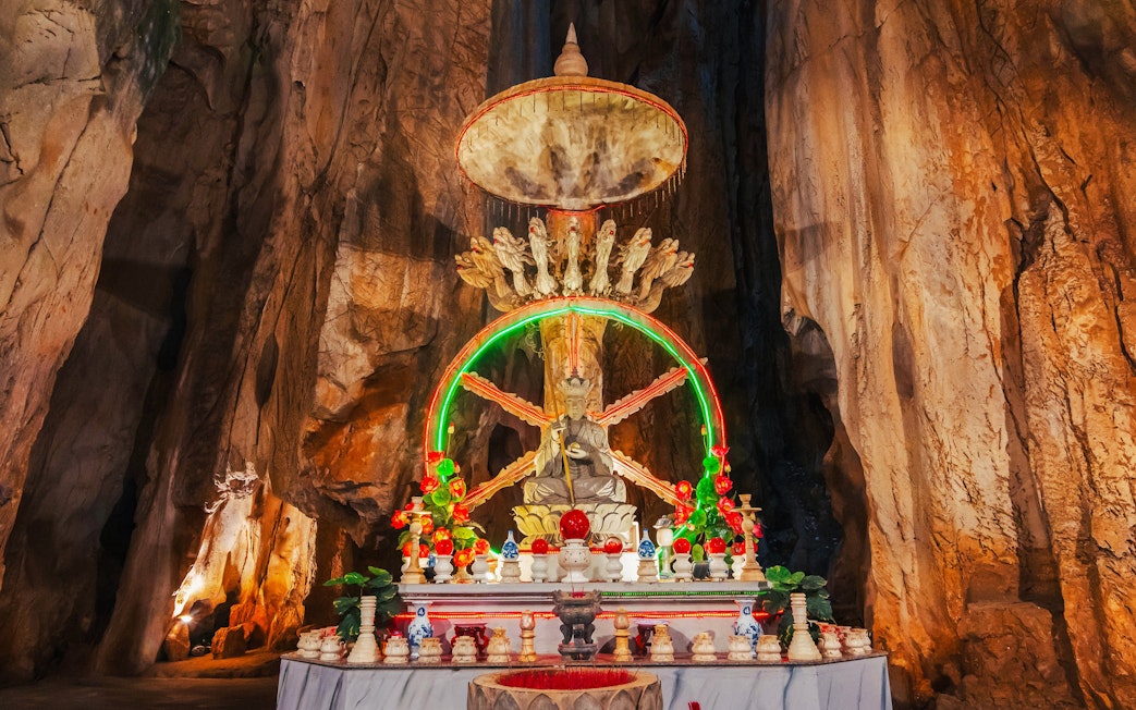 Altar with statue inside a cave at Sơn Trà Peninsula, Đà Nẵng, Vietnam.