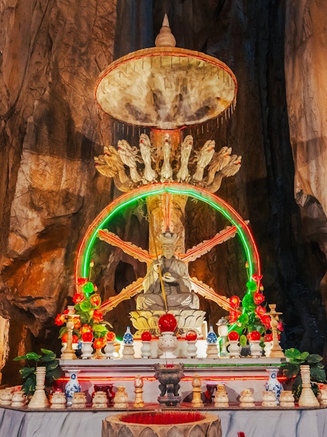 Altar with statue inside a cave at Sơn Trà Peninsula, Đà Nẵng, Vietnam.