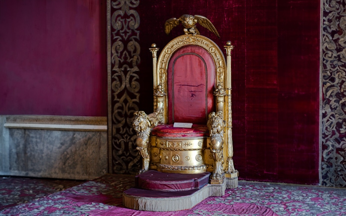 Throne in the Royal Palace of Naples with ornate gold and red design.
