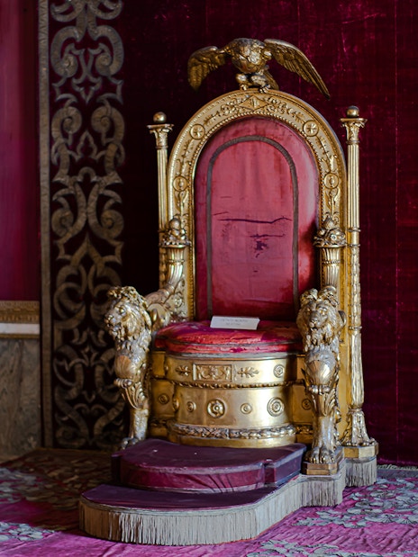 Throne in the Royal Palace of Naples with ornate gold and red design.
