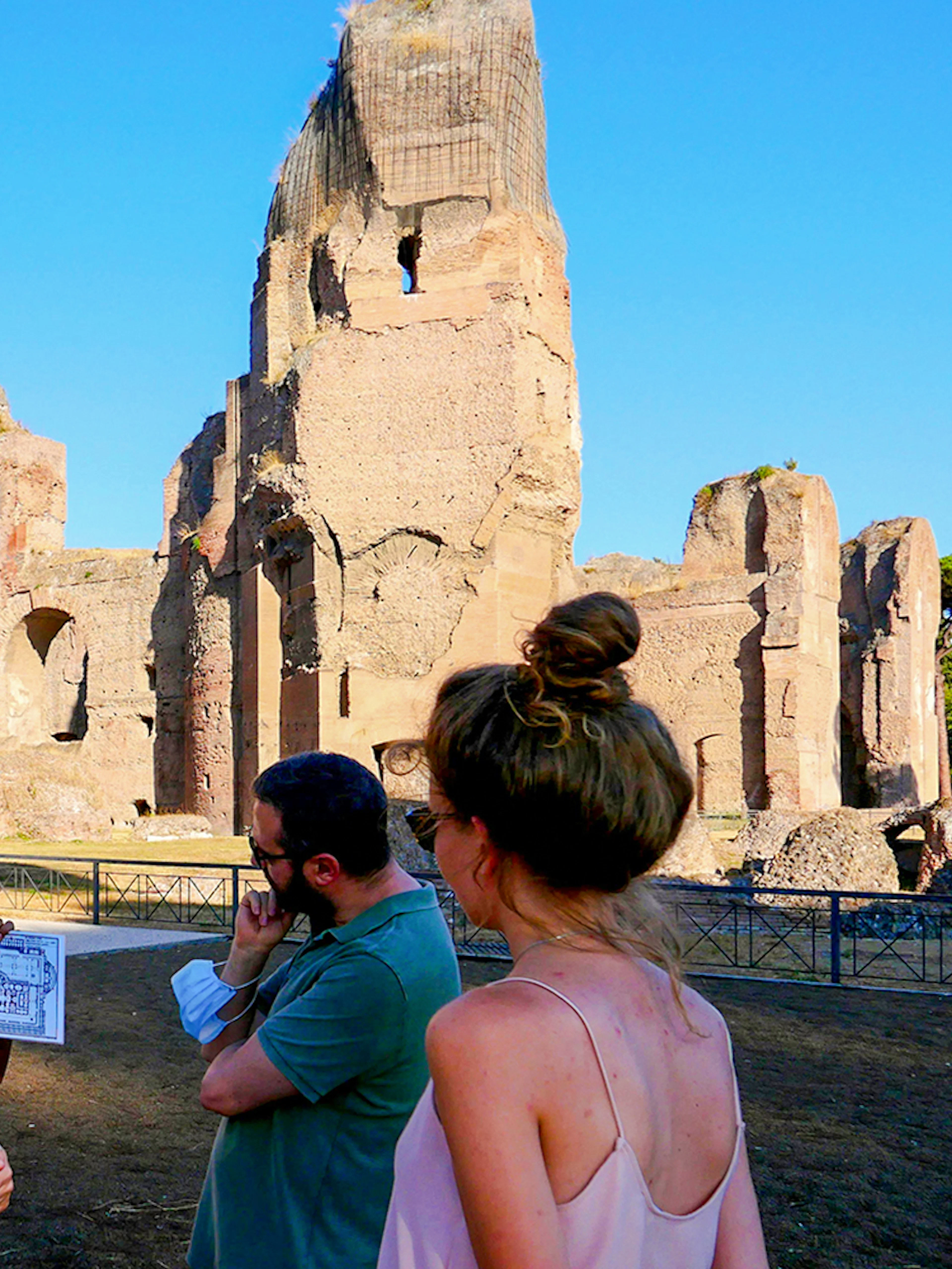 Visitors exploring the ancient Baths of Caracalla ruins in Rome, Italy.