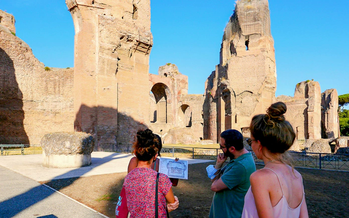 Visitors exploring the ancient Baths of Caracalla ruins in Rome, Italy.