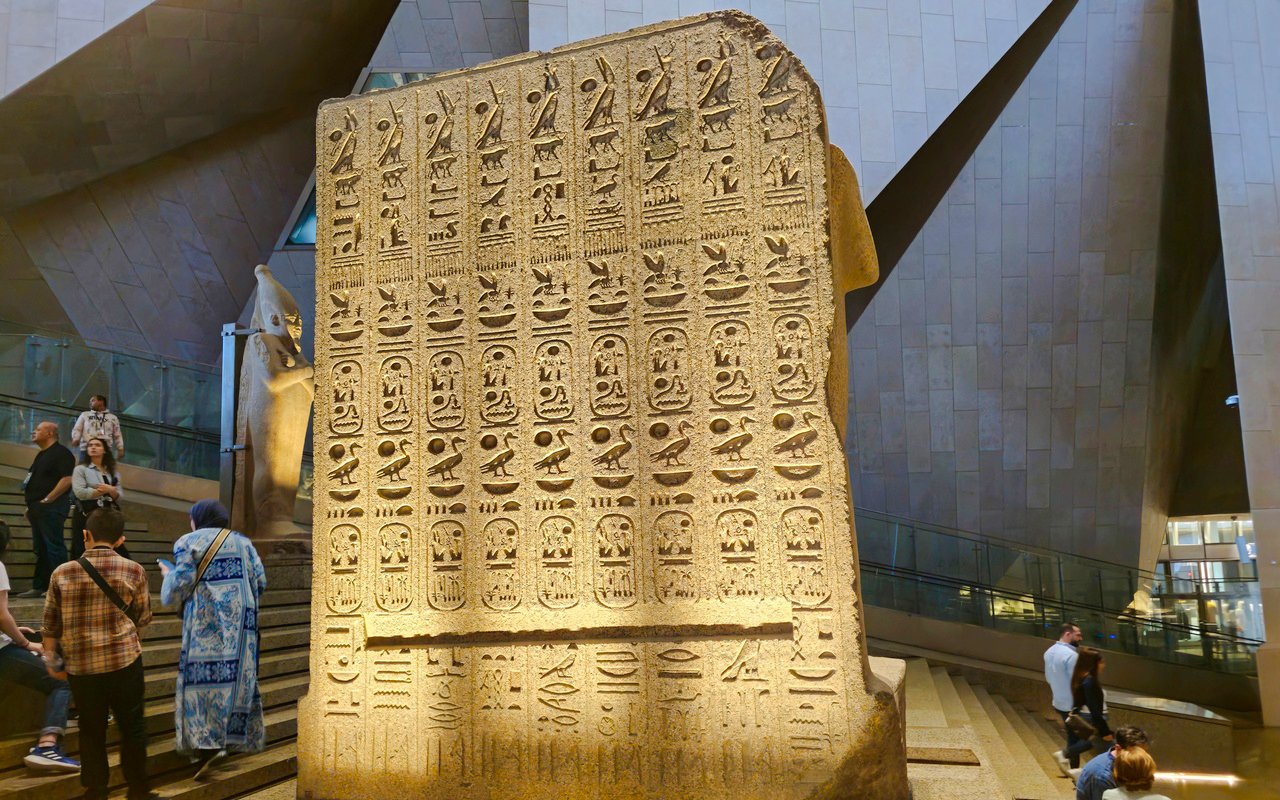 Ancient Egyptian stone slab with hieroglyphs at the Grand Egyptian Museum.