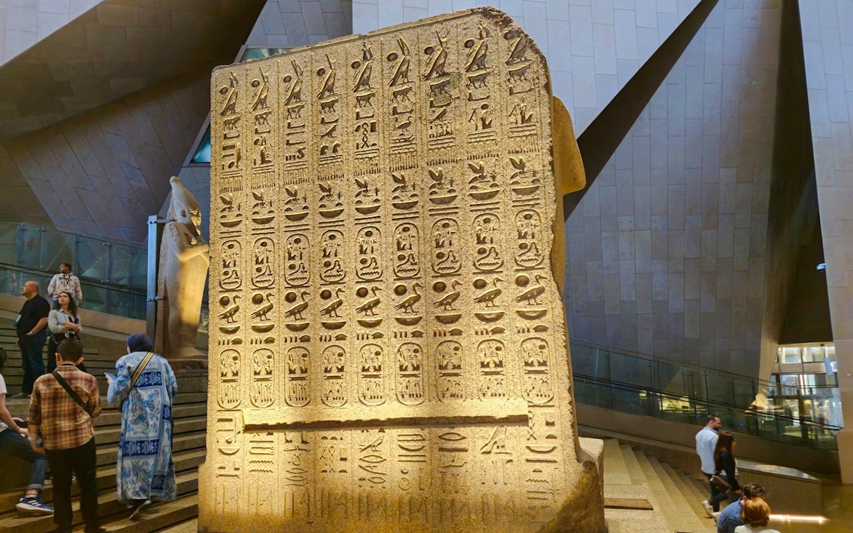Ancient Egyptian stone slab with hieroglyphs at the Grand Egyptian Museum.