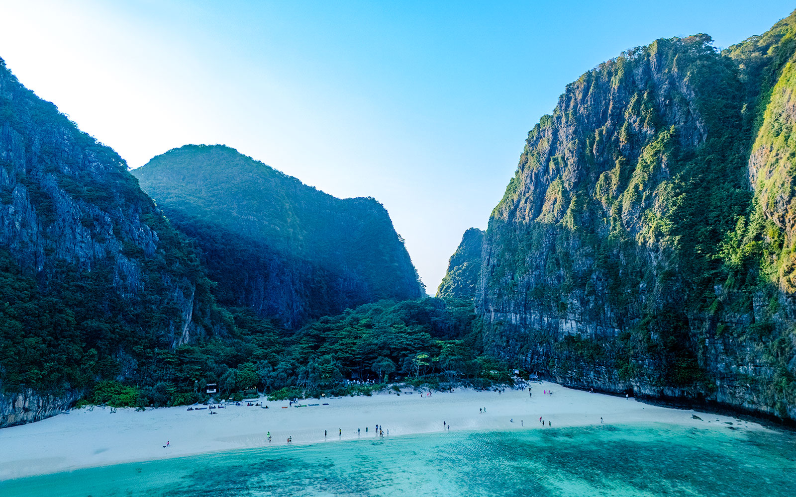 Early morning aerial view of Maya Bay beach and surrounding cliffs in Thailand.