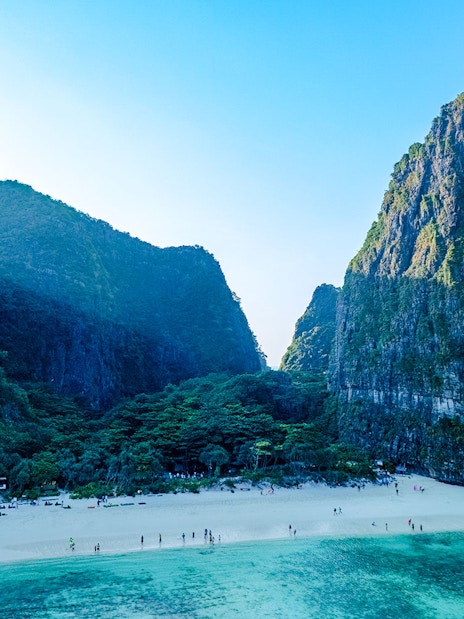 Early morning aerial view of Maya Bay beach and surrounding cliffs in Thailand.
