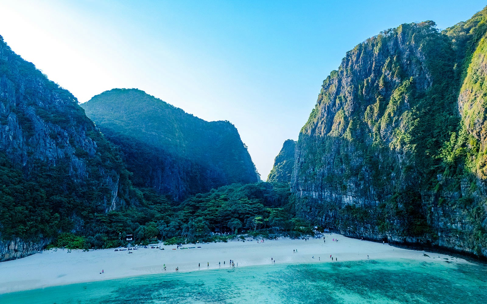 Early morning aerial view of Maya Bay beach and surrounding cliffs in Thailand.