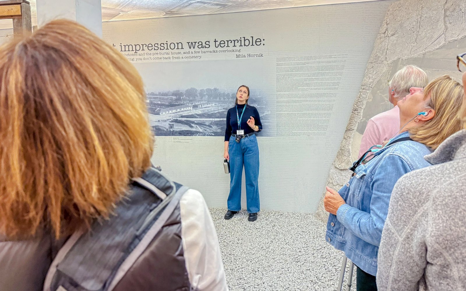 Tour guide explaining exhibit to visitors at Oskar Schindler’s Factory.