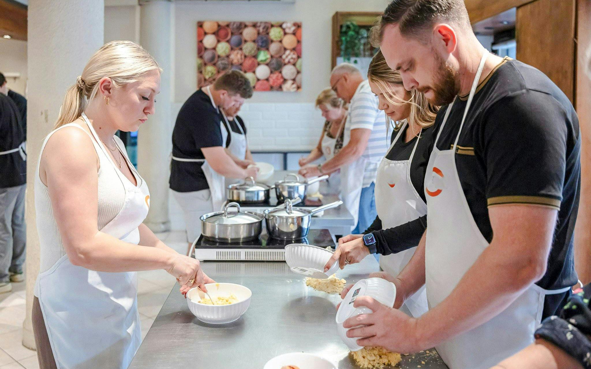 Participants making pasta in a Florence cooking class.